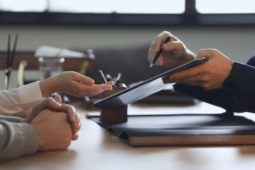 Male lawyer working with clients in office, closeup