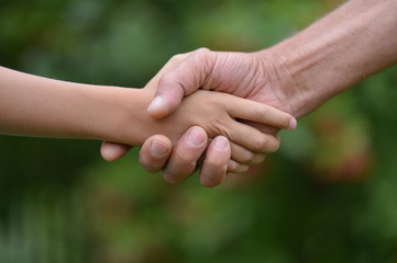 Portrait of granddaughter and grandfather holding hands