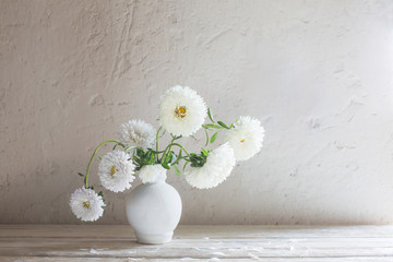 asters in vase on white wooden table © Maya Kruchancova