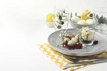 Fototapeta na wymiar Festive Easter table setting with beautiful floral decor. Space for text
