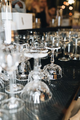 Fototapeta na wymiar Many clean wineglasses in bar, professional equipment