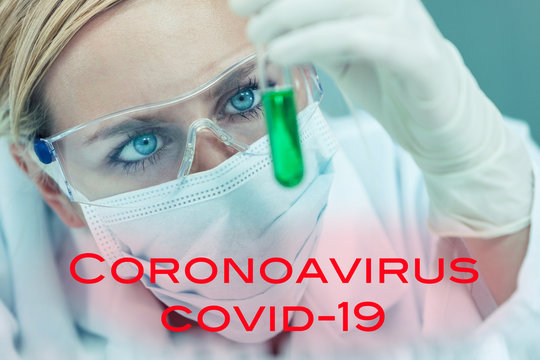Female Woman Research Scientist With Test Tube In Coronavirus COVID-19 Laboratory