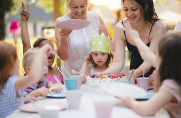 Kids birthday party outdoors in garden in summer, celebration concept.