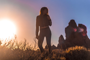 Lifestyle, a young brunette in a beautiful orange sunset on the Teide volcano. Tenerife