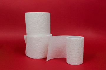 Three rolls of toilet paper on red background