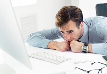 Shocked, distraught or tired, unhappy confident businessman in shirt, working with computer at office. Business, job and education concept picture.