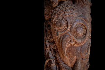 Old art bird wooden carving with clipping paths on blak background, free space for your design or text.