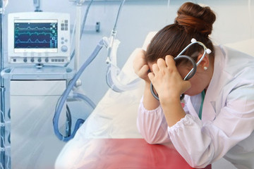 girl doctor with a stethoscope in her hand covered her head with