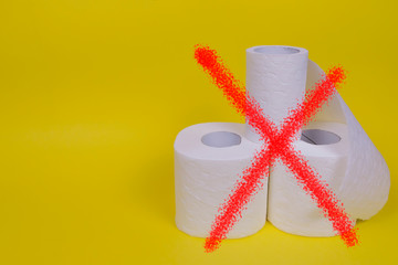 Three rolls of toilet paper on yellow background