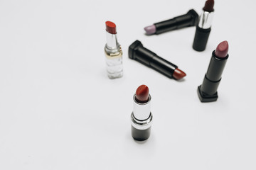 Obraz premium Lipsticks of different colors on wooden background 