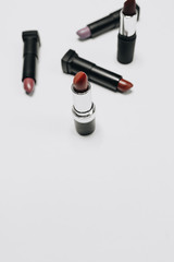 Obraz premium Lipsticks of different colors on wooden background 