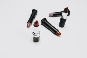 Lipsticks of different colors on wooden background	