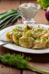 Dumplings with meat and sour cream. Russian national dish. Still-life.