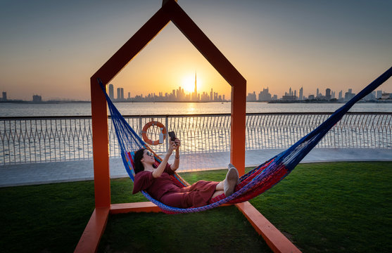 Woman enjoying beautiful sunset in Dubai from the creek harbor