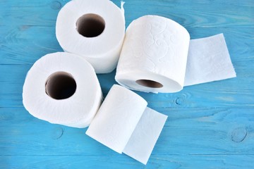 roll of soft toilet paper with selective focus on blue wooden background. toilet paper for Covid-19 pandemic. Increased potential. high demand