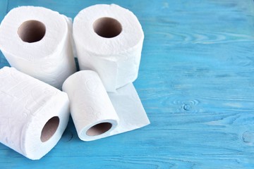 roll of soft toilet paper with selective focus on blue wooden background. toilet paper for Covid-19 pandemic. Increased potential. high demand