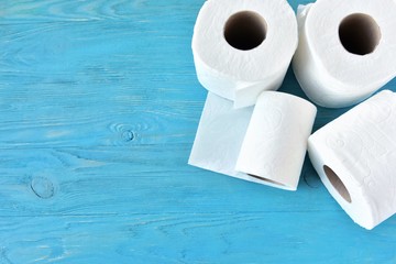 roll of soft toilet paper with selective focus on blue wooden background. toilet paper for Covid-19 pandemic. Increased potential. high demand