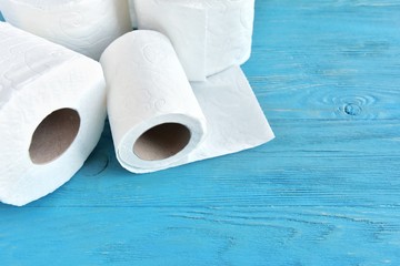 roll of soft toilet paper with selective focus on blue wooden background. toilet paper for Covid-19 pandemic. Increased potential. high demand