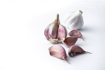 garlic cloves and garlic bulb and white background
