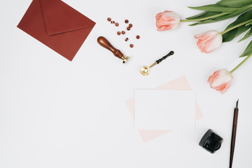 Envelopes, gifts and tulips on white background