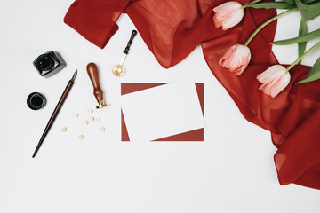 Envelopes, gifts and tulips on white background