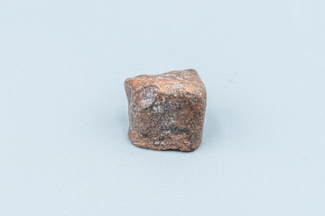 Fototapeta premium Chondrite Meteorite L6W2 Type isolated, piece of rock formed as an asteroid in the universe at during Solar System creation. The meteorite comes from an asteroid fall impacting Earth at Atacama Desert