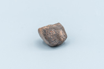Fototapeta premium Chondrite Meteorite L6W2 Type isolated, piece of rock formed as an asteroid in the universe at during Solar System creation. The meteorite comes from an asteroid fall impacting Earth at Atacama Desert