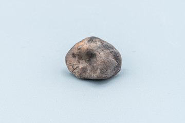 Fototapeta premium Chondrite Meteorite L6W2 Type isolated, piece of rock formed as an asteroid in the universe at during Solar System creation. The meteorite comes from an asteroid fall impacting Earth at Atacama Desert