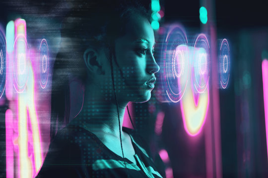 Beautiful Asian Woman Using Futuristic Computer Screen In Neon Light