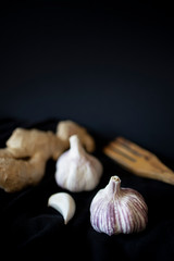 Garlic and ginger in a black background