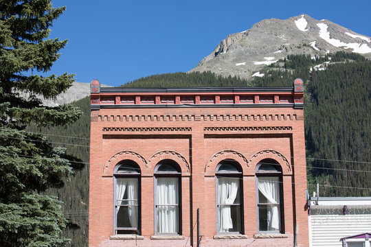 Old brick building in Silverton, CO with mountain in background