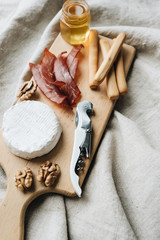 Delicious fresh bruschettas with eggs, salmon, olives and meat , traditional Italian cuisine, ingredients on white table