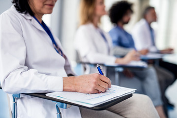 Group of doctors on conference, medical team sitting and listening.