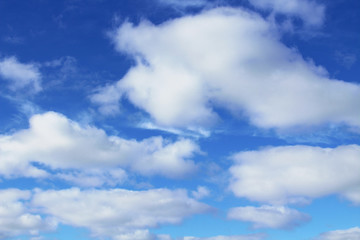 Beautiful blue sky and white large cumulus clouds. Close-up. Background. Scenery.