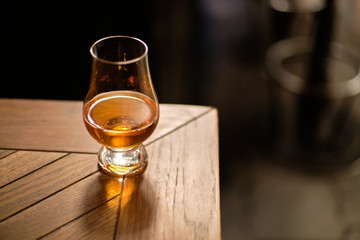 Glass of good whisky in glen glencairn glass on table