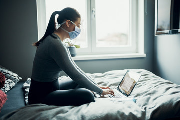 Schoolgirl studies at home via e-learning because of Corona Virus Covid-19 quarantine, homeschooling