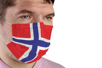 Portrait of adult caucasian man who wears protective mask on his face against influenza and protect health from bacteria. Image of the flag of Norway.