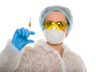 female doctor in medical mask protected from coronovirus dosing medicine from syringe