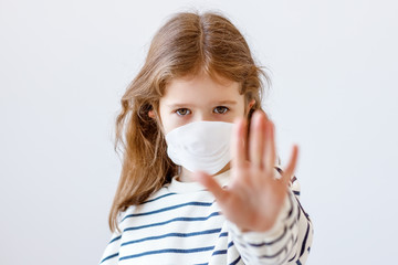 Little girl in medical mask stopping disease
