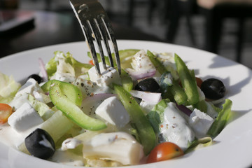 Fresh greek salad - feta cheese, tomato, lettuce, black olives and onion.