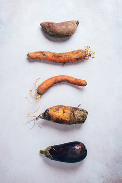 Naklejki Spotted carrot, eggplant, beetroot. Ugly vegetables on grey background. Ugly food concept. Top view, flat lay.