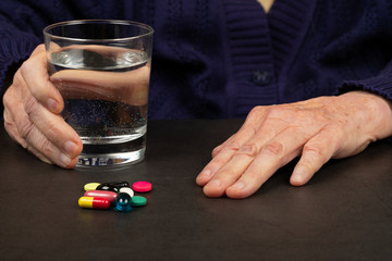 Elderly hands on dark background