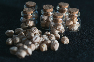 macro photography of raw chickpeas in glass jars