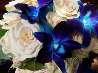 wedding bouquet of tea spray roses and blue orchids