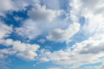 White fluffy clouds in the blue sky in sunny weather_