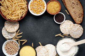 Selection of gluten free food. Chickpeas, bread, couscous, bulgur, pasta, bread, flour, quinoa on a stone background  with copy space for your text