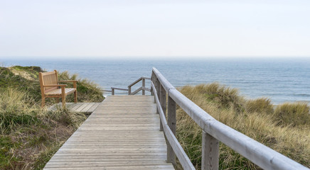 Fototapeta na wymiar bench on a dune off the North Sea coast