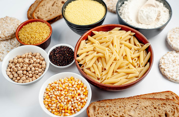 Selection of gluten free food. Chickpeas, bread, couscous, bulgur, pasta, bread, flour, quinoa on a white background, isolated