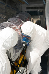 men with isolated ambulance bed for pandemic virus or ebola