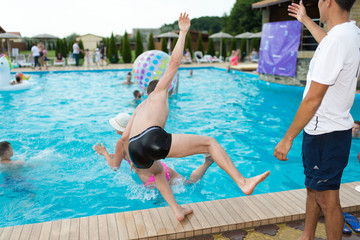 Naklejka premium man slipped by the pool